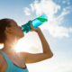 Female drinking a fresh water from bottle.